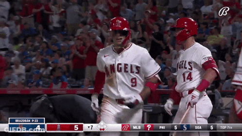 Two Baseball Players In Angels Uniforms Celebrating GIF