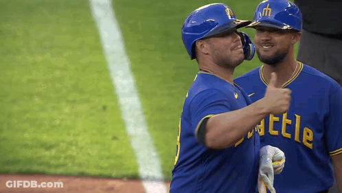 Two Baseball Players In Blue Shirts Saying Battle GIF