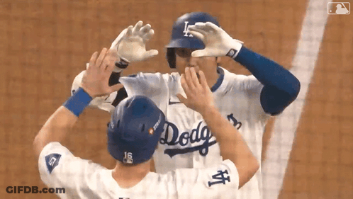 Two Baseball Players In Dodgers Uniforms Hugging GIF