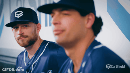 Two Baseball Players In Dugout With Carsheld Logo GIF