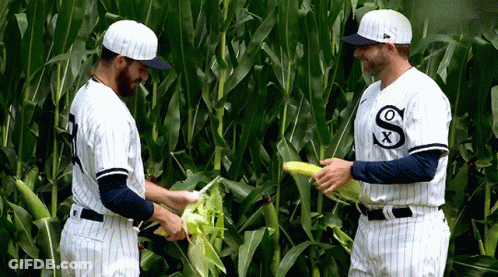 Two Baseball Players In White Uniforms With Letter S GIF