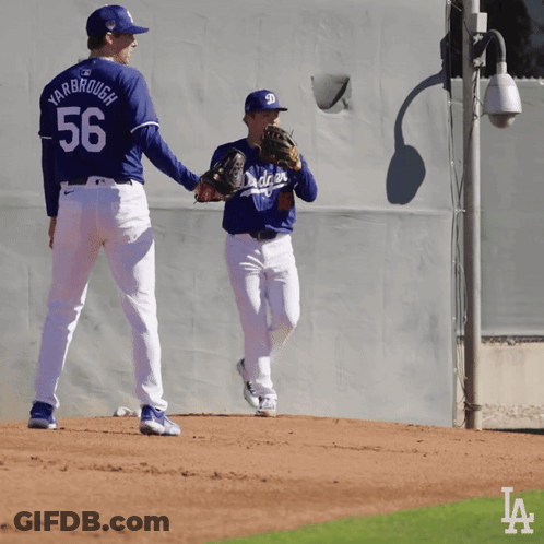 Two Baseball Players One Of Whom Has The Number 56 On Their Back GIF