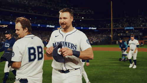 Two Baseball Players One Of Whom Is Wearing A Jersey That Says Bb GIF