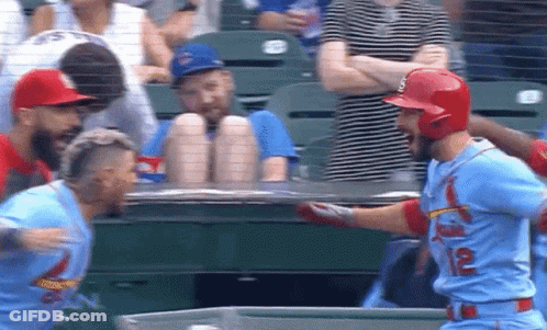 Two Baseball Players Standing In Field GIF