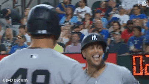 Two Baseball Players Standing Next To Each Other GIF