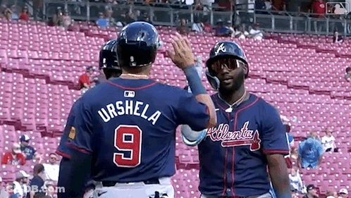 Two Baseball Players Standing Next To Each Other GIF