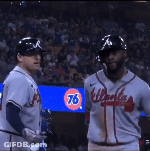 Two Baseball Players Wearing A Jersey That Says Atlanta GIF