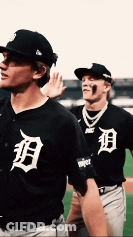 Two Baseball Players Wearing Black Uniforms With The Letter D On The Front GIF