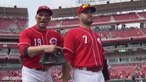 Two Baseball Players Wearing Red Uniforms With The Number 19 On The Front GIF