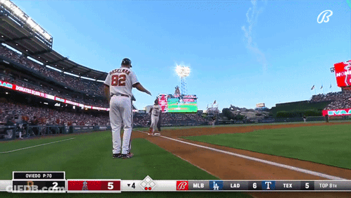 Two Baseball Players With A And GE On Shirts GIF