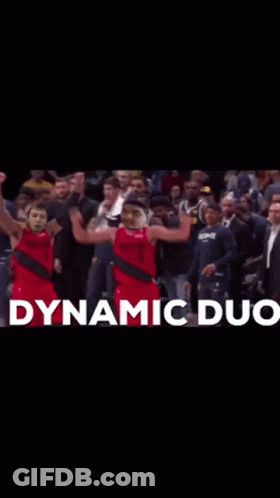 Two Basketball Players Are Celebrating In Front Of A Crowd With Dynamic Duo Written In White GIF