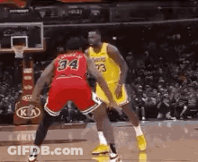 Two Basketball Players Are Playing A Game Of Basketball . GIF