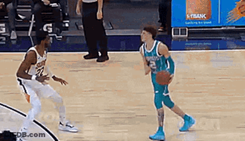 Two Basketball Players Are Playing A Game Of Basketball On A Court And One Of Them Is Dribbling The Ball . GIF