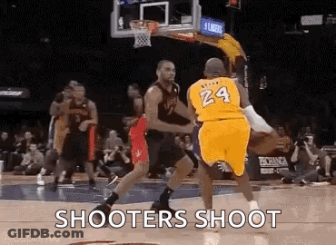Two Basketball Players Are Playing A Game Of Basketball On A Court And One Of Them Is Wearing A Number 24 Jersey . GIF