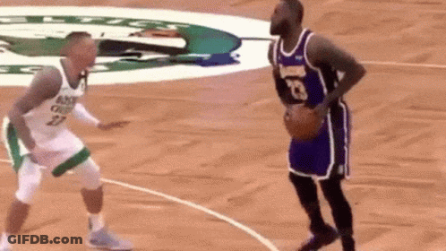 Two Basketball Players Are Playing A Game Of Basketball On A Court . One Of The Players Has The Number 23 On His Jersey GIF