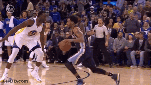 Two Basketball Players Are Playing A Game Of Basketball On A Court While A Referee Watches . GIF