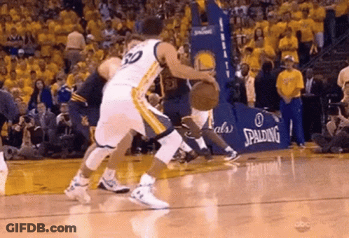 Two Basketball Players Are Playing A Game Of Basketball On A Court With A Spalding Ad In The Background . GIF