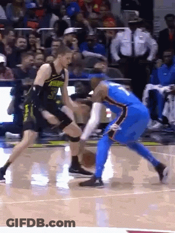 Two Basketball Players Are Playing A Game On A Court GIF