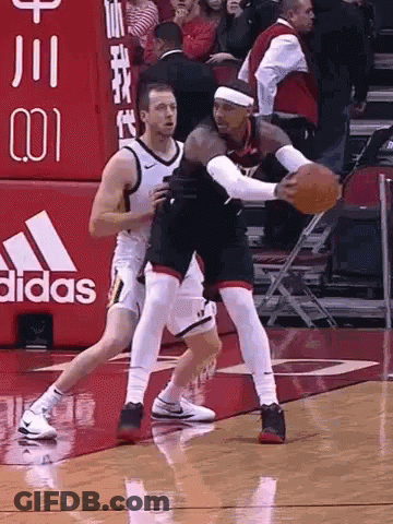Two Basketball Players Are Playing A Game On A Court With An Adidas Sign In The Background GIF