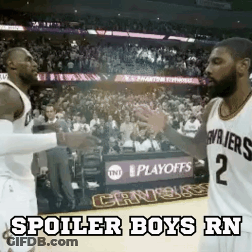 Two Basketball Players Are Shaking Hands On The Court During A Game . GIF