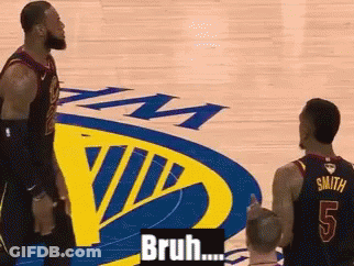 Two Basketball Players Are Standing In Front Of A Golden State Warriors Logo GIF
