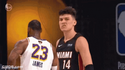 Two Basketball Players Are Standing Next To Each Other During A Game . One Of The Players Has The Number 23 On His Jerse GIF