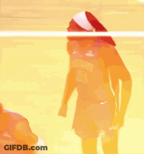 Two Basketball Players Are Standing Next To Each Other On A Court . One Of The Players Is Wearing A Detroit Jersey . GIF