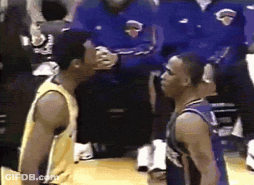 Two Basketball Players Are Standing Next To Each Other On The Court GIF