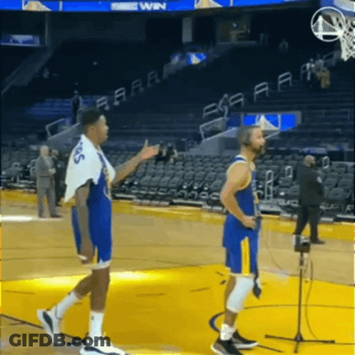Two Basketball Players Are Standing On A Basketball Court Talking To Each Other GIF