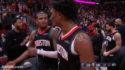 Two Basketball Players From The Houston Rockets Are Hugging Each Other GIF