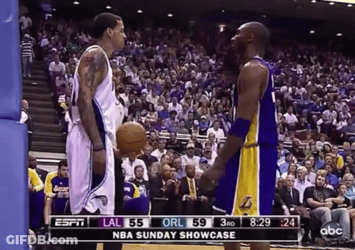 Two Basketball Players In Front Of Crowd GIF
