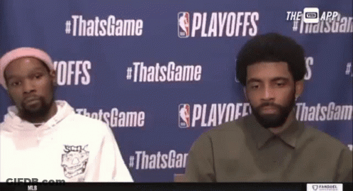Two Basketball Players In Front Of Playoffs Wall GIF