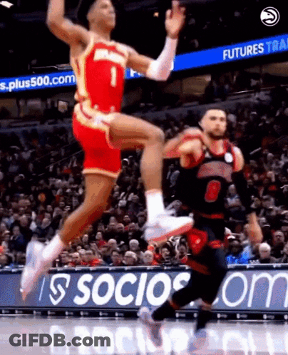 Two Basketball Players Jumping In Front Of Socios.com Sign GIF