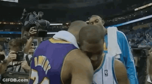 Two Basketball Players Kissing In Front Of Crowd GIF