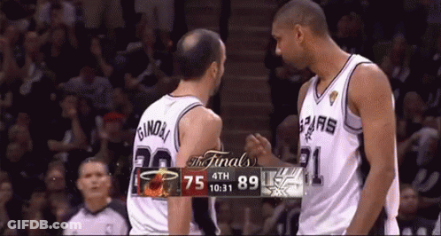 Two Basketball Players Near Scoreboard GIF
