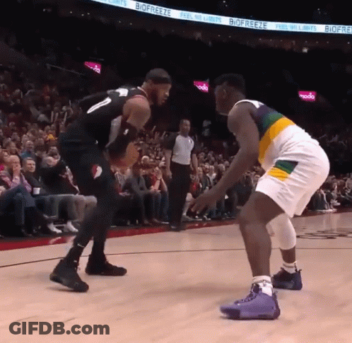 Two Basketball Players On A Court With Biofreeze Advertisements On The Wall GIF