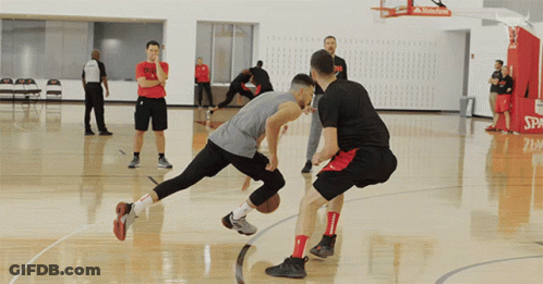Two Basketball Players On A Court With The Word Spalding On The Hoop GIF