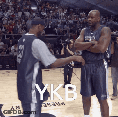 Two Basketball Players On A Court With Ykb Written On The Floor GIF