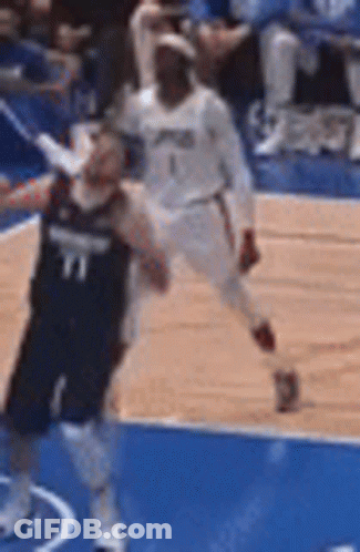 Two Basketball Players On Blue Court GIF