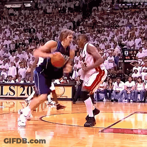 Two Basketball Players On Court Scoreboard Ls20 GIF