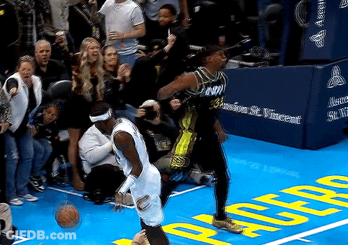 Two Basketball Players On Court With Crowd GIF