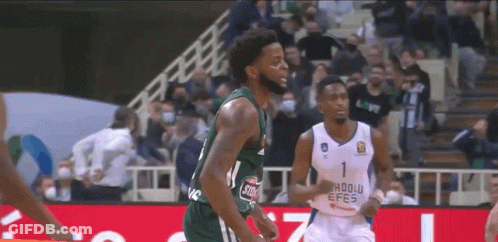 Two Basketball Players On Court With Crowd GIF