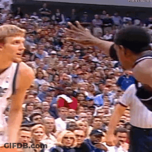 Two Basketball Players Playing In Front Of Crowd GIF