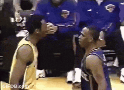 Two Basketball Players Standing Next To Each Other On A Court GIF