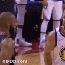 Two Basketball Players Standing Together On Court GIF
