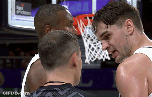 Two Basketball Players Talking In Front Of Liga Endesa Screen GIF