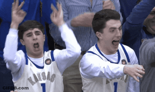 Two Basketball Players Wearing Kansas Jerseys Are Celebrating GIF