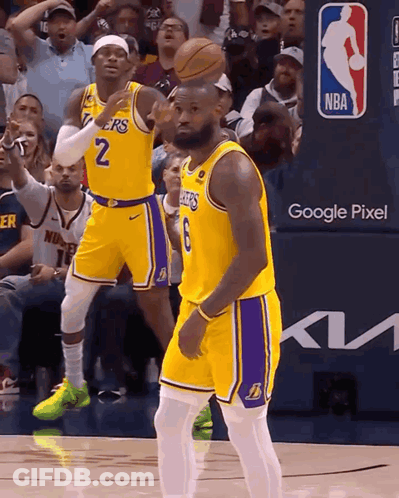 Two Basketball Players Wearing Lakers Uniforms Are On The Court GIF