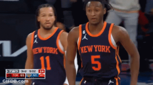 Two Basketball Players Wearing New York Uniforms Are Standing On The Court GIF