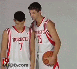 Two Basketball Players Wearing Rockets Jerseys Stand Next To Each Other GIF